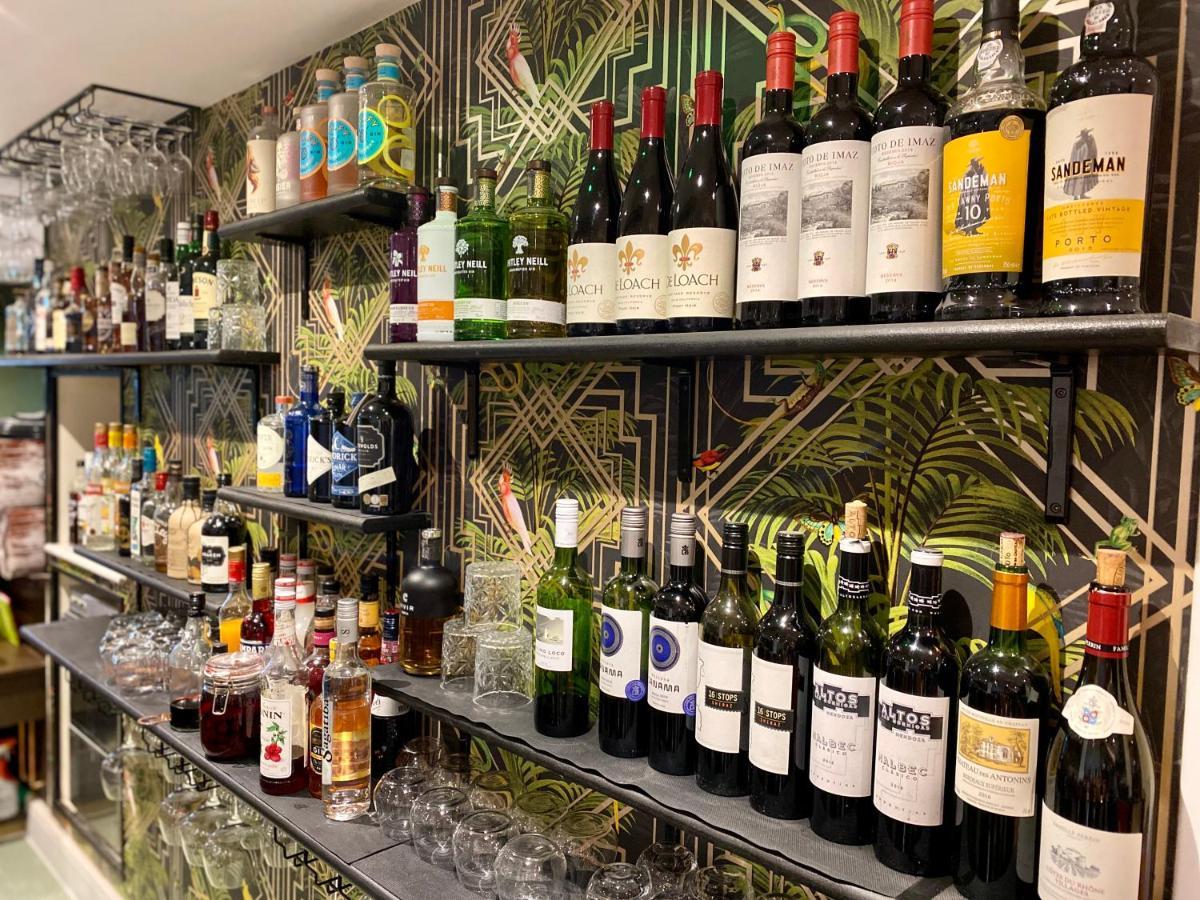 Hotel The Lion At West Pennard Exterior foto A selection of wine and spirits at the bar